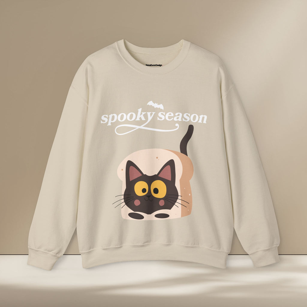 Beige sweatshirt with a cat design and 'spooky season' text on a beige background