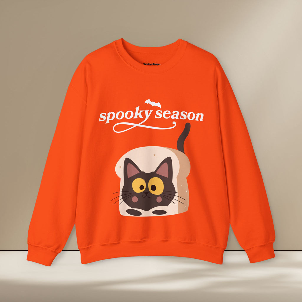 Orange sweatshirt with a cat design and 'spooky season' text on a beige background