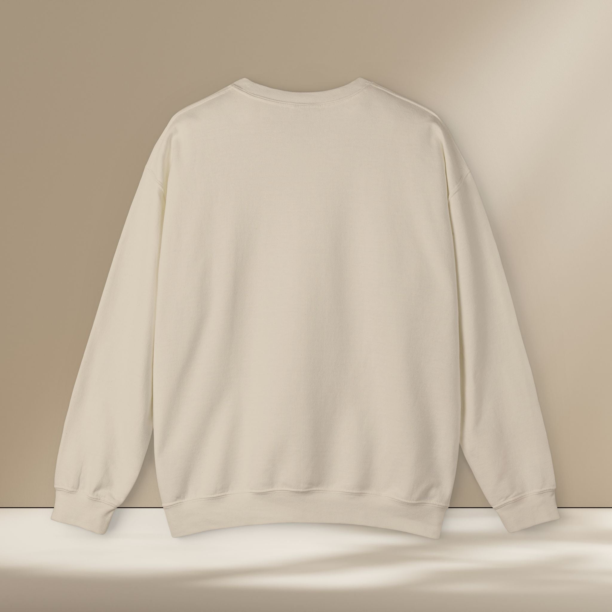 Beige sweatshirt on a white surface with a beige background